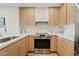 Modern kitchen with stainless steel appliances, elegant countertops, and light wood cabinets at 9708 E Via Linda Rd # 1350, Scottsdale, AZ 85258