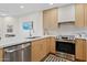 Modern kitchen featuring stainless steel appliances, light wood cabinetry and white countertops at 9708 E Via Linda Rd # 1350, Scottsdale, AZ 85258