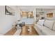 Bright living room featuring stylish furniture, wood floors, and an open layout to the modern kitchen at 9708 E Via Linda Rd # 1350, Scottsdale, AZ 85258