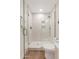 Bathroom shower with glass door and white vertical tile at 9708 E Via Linda Rd # 1350, Scottsdale, AZ 85258