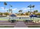 Attractive tennis courts with seating areas and shade umbrellas offer a welcoming space for sports and recreation at 9708 E Via Linda Rd # 1350, Scottsdale, AZ 85258