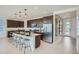 Modern kitchen with a large island, stainless steel appliances, and dark wood cabinetry at 10132 E Ursula Ave, Mesa, AZ 85212