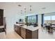 Open-concept kitchen with an island, stainless steel appliances, and seamless flow into the living areas at 10132 E Ursula Ave, Mesa, AZ 85212