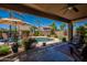 Entertainer's backyard with covered patio, refreshing pool and lush landscaping at 102 W Raven Dr, Chandler, AZ 85286