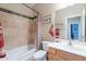 Cozy bathroom with a shower-tub combo and a mirrored vanity at 102 W Raven Dr, Chandler, AZ 85286