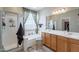 Bathroom featuring a shower, a soaking tub, and a double sink vanity with plenty of light at 102 W Raven Dr, Chandler, AZ 85286