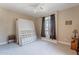 A bedroom with a carpeted floor, a ceiling fan and a window at 102 W Raven Dr, Chandler, AZ 85286