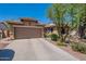 Charming home features a two-car garage, well-maintained landscape and desert surroundings at 102 W Raven Dr, Chandler, AZ 85286