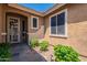 Inviting front entry featuring a decorative security door and vibrant desert landscaping at 102 W Raven Dr, Chandler, AZ 85286