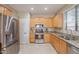 Bright kitchen showcasing stainless steel appliances and countertops, illuminated by recessed lighting at 102 W Raven Dr, Chandler, AZ 85286