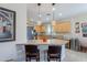 Well-appointed kitchen with a breakfast bar and adjacent dining area, great for entertaining at 102 W Raven Dr, Chandler, AZ 85286