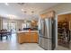 Bright kitchen featuring a stainless steel refrigerator and an open layout to the living space at 102 W Raven Dr, Chandler, AZ 85286