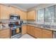 A bright kitchen with stainless steel appliances and ample granite countertop space at 102 W Raven Dr, Chandler, AZ 85286