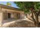 Backyard featuring covered patio, seating, and mature landscaping at 10505 W Campana Dr, Sun City, AZ 85351