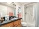 Updated bathroom has tiled shower and granite-topped vanity at 10505 W Campana Dr, Sun City, AZ 85351
