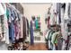 Walk-in closet features dual hanging rods and shelves for storage at 10505 W Campana Dr, Sun City, AZ 85351