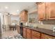 Beautiful kitchen with stainless steel appliances, wood cabinets, and dining table nearby at 10505 W Campana Dr, Sun City, AZ 85351