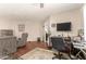 Relax in this comfortable living room featuring wood floors and a ceiling fan at 10505 W Campana Dr, Sun City, AZ 85351