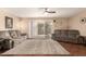 Bright living room features comfortable seating, ceiling fan and sliding glass doors to the backyard at 10505 W Campana Dr, Sun City, AZ 85351