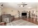Spacious living room with hardwood floors, ceiling fan, and comfortable reclining furniture at 10505 W Campana Dr, Sun City, AZ 85351