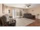 Cozy living room with hardwood floors, ceiling fan, and comfortable reclining furniture at 10505 W Campana Dr, Sun City, AZ 85351