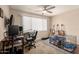 Well-lit office space with a large window and ceiling fan at 10505 W Campana Dr, Sun City, AZ 85351