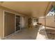 Covered patio area featuring seating, sliding glass doors, and outdoor access at 10505 W Campana Dr, Sun City, AZ 85351