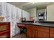 Functional bathroom with granite counters, and shower with curtain at 11375 E Sahuaro Dr # 1062, Scottsdale, AZ 85259