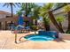 Community hot tub surrounded by palm trees, plants, and seating area, ideal for relaxation at 11375 E Sahuaro Dr # 1062, Scottsdale, AZ 85259