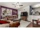 Cozy living room featuring a fireplace, ceiling fan and stylish furnishings at 11375 E Sahuaro Dr # 1062, Scottsdale, AZ 85259
