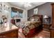 Comfortable main bedroom with dark accent wall, hardwood floors, and natural light at 11375 E Sahuaro Dr # 1062, Scottsdale, AZ 85259