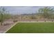 Large backyard with artificial grass, desert landscaping, and metal fencing with mountain views at 11470 E Yeager Cyn, Gold Canyon, AZ 85118