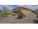 Spacious backyard with desert landscaping, stone ground cover, and artificial grass at 11470 E Yeager Cyn, Gold Canyon, AZ 85118