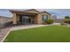 Well-maintained backyard featuring a patio, a lush green lawn, and manicured landscaping at 11470 E Yeager Cyn, Gold Canyon, AZ 85118