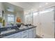 This bathroom has a double sink vanity with granite countertop and a walk-in shower at 11470 E Yeager Cyn, Gold Canyon, AZ 85118