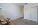An empty bedroom with plush carpet, white walls, and a sitting chair at 11470 E Yeager Cyn, Gold Canyon, AZ 85118