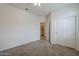 This bedroom showcases a ceiling fan, carpeted floors, and an ensuite laundry area at 11470 E Yeager Cyn, Gold Canyon, AZ 85118