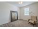An empty bedroom with neutral walls, plush carpet, and a large framed mirror at 11470 E Yeager Cyn, Gold Canyon, AZ 85118