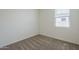 An empty bedroom featuring a window with blinds and plush carpet at 11470 E Yeager Cyn, Gold Canyon, AZ 85118