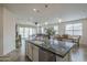 Open-concept kitchen with granite countertops and island that flows into living and dining areas at 11470 E Yeager Cyn, Gold Canyon, AZ 85118