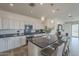 Bright kitchen with white cabinetry, granite countertops, stainless steel appliances, and pendant lights at 11470 E Yeager Cyn, Gold Canyon, AZ 85118
