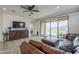 Spacious living room with sliding glass doors that lead to backyard and a mounted TV at 11470 E Yeager Cyn, Gold Canyon, AZ 85118
