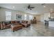 Comfortable living room with a leather sofa, ceiling fan, and tile floors at 11470 E Yeager Cyn, Gold Canyon, AZ 85118