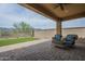 Inviting covered patio with comfortable seating and a view of the green backyard at 11470 E Yeager Cyn, Gold Canyon, AZ 85118