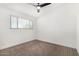 Inviting bedroom with neutral carpet, ceiling fan, and sun filled window at 12453 N 29Th Ave, Phoenix, AZ 85029