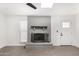 Bright living room with stylish gray brick fireplace and modern gray tile floors at 12453 N 29Th Ave, Phoenix, AZ 85029
