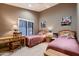 Cozy bedroom featuring twin beds, a desk, and artwork on the walls at 12754 E Laurel Ln, Scottsdale, AZ 85259