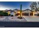 Charming single-story home featuring a three-car garage and mature desert landscaping with a prominent cactus at 12754 E Laurel Ln, Scottsdale, AZ 85259