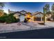 Single-story home boasting a three-car garage, desert landscaping, and a driveway with ample parking at 12754 E Laurel Ln, Scottsdale, AZ 85259