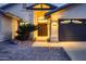 Inviting home featuring a double-door entrance and three-car garage, enhanced by desert landscaping at 12754 E Laurel Ln, Scottsdale, AZ 85259